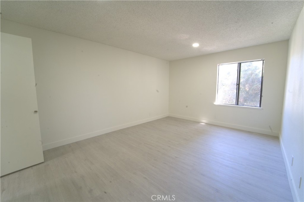 600 West 3rd Street, Unit B211 Santa Ana, CA 92701 - Photo 3 of 21 an empty room with wooden floor and windows