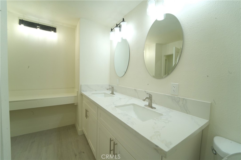 600 West 3rd Street, Unit B211 Santa Ana, CA 92701 - Photo 8 of 21 a bathroom with a sink and a mirror