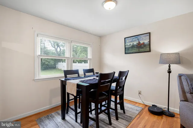 a view of a dining room with furniture and a window