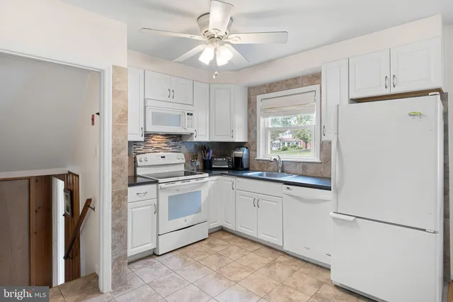 a kitchen with stainless steel appliances granite countertop a refrigerator sink and cabinets