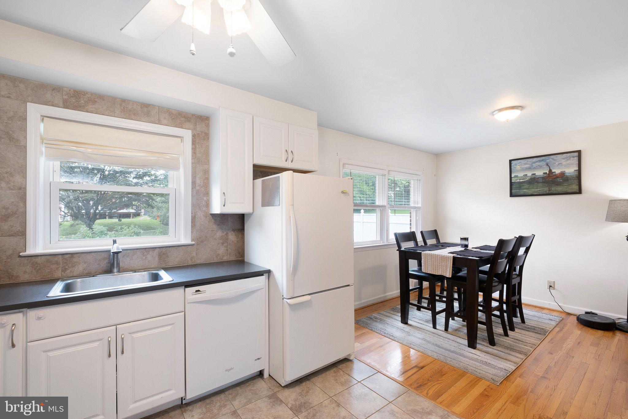 603 Milltown Road Wilmington, DE 19808 - Photo 8 of 28 a kitchen with stainless steel appliances granite countertop a dining table chairs and a refrigerator