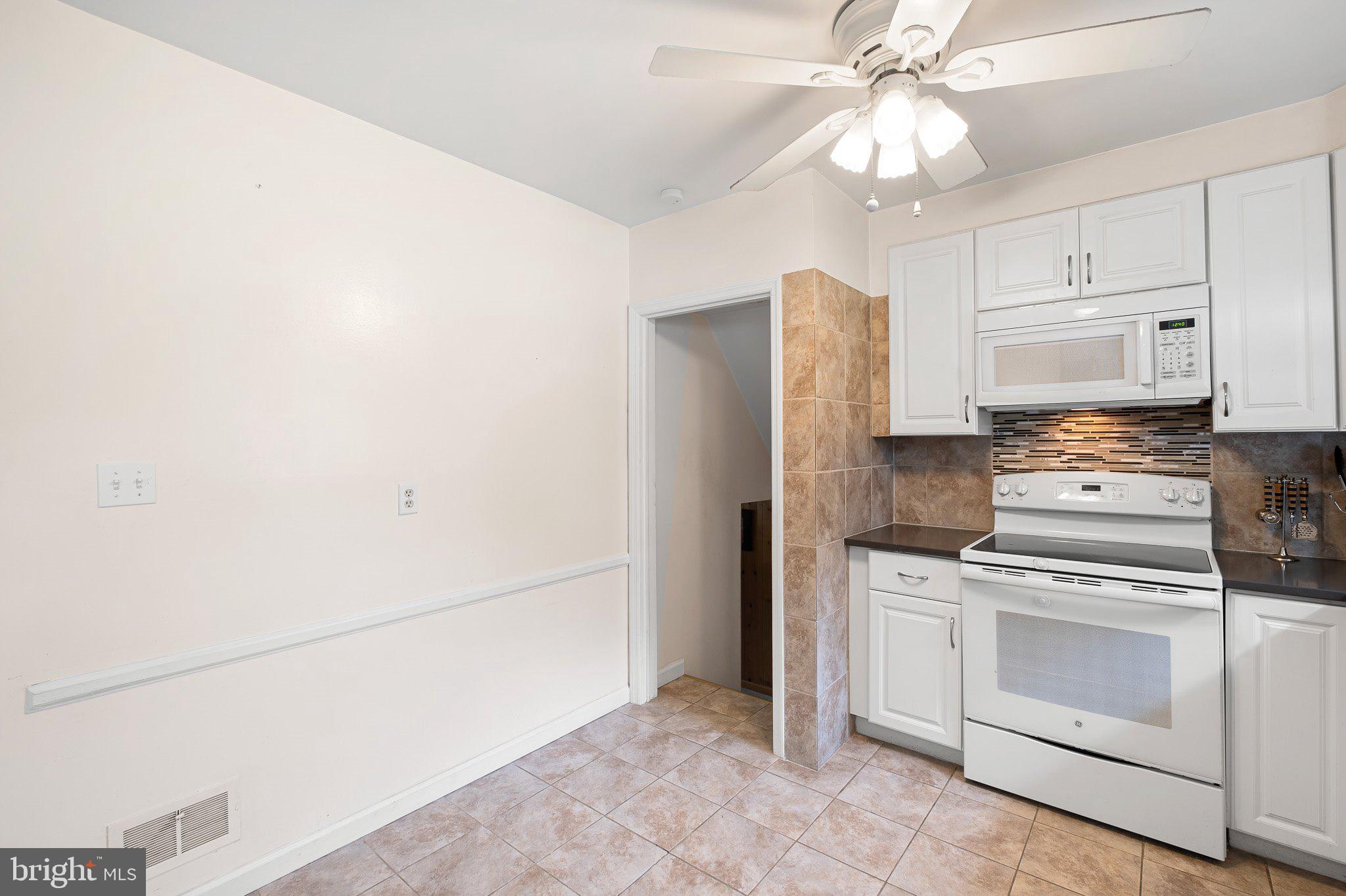 603 Milltown Road Wilmington, DE 19808 - Photo 10 of 28 a kitchen with stainless steel appliances white cabinets and white appliances