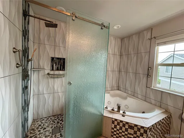 a bathroom with a bathtub and a shower