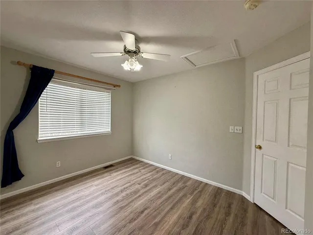 a bathroom with a granite countertop sink a toilet a mirror and shower