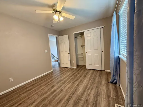 wooden floor in an empty room with a window