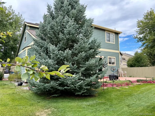 a view of a house with a yard and sitting area