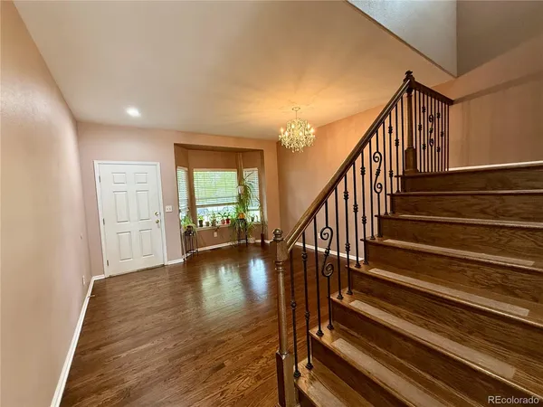 a view of an entryway with wooden floor