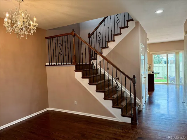 a view of entryway and hall with wooden floor