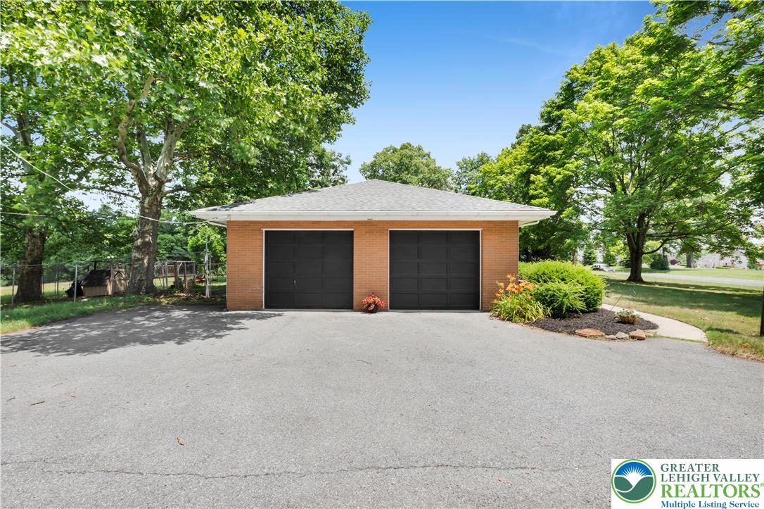 5747 Kernsville Road Orefield, PA 18069 - Photo 47 of 56 a front view of a house with a yard and garage