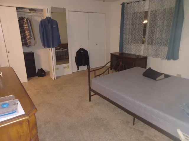 a bedroom with a bed and a chair