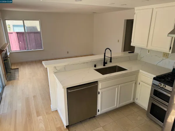 a kitchen with a sink cabinets and appliances