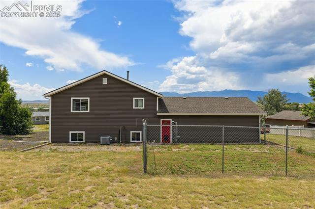 10925 Double D Road Fountain, CO 80817 - Photo 32 of 33 Back of house featuring a mountain view and roof with shingles