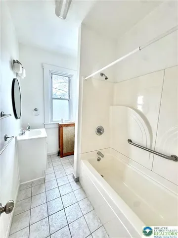 a bathroom with a bathtub a toilet a sink and mirror