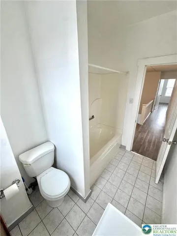 a bathroom with a bathtub and toilet