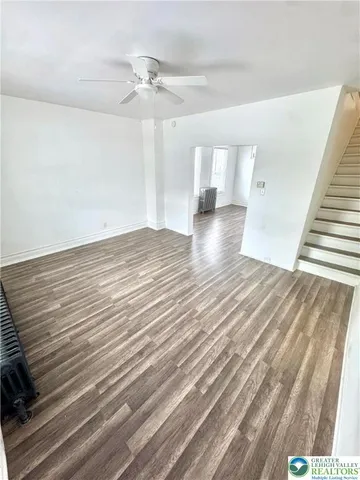 wooden floor in an empty room with a window
