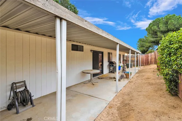 a view of a patio with table and chairs and potted plants