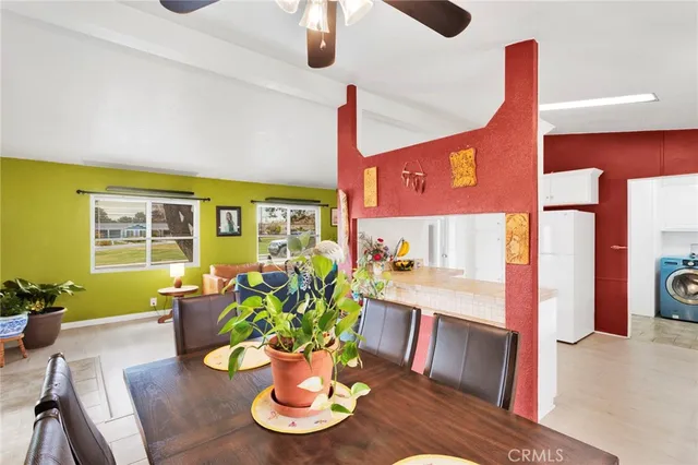 a living room with furniture flowerpot and wooden floor