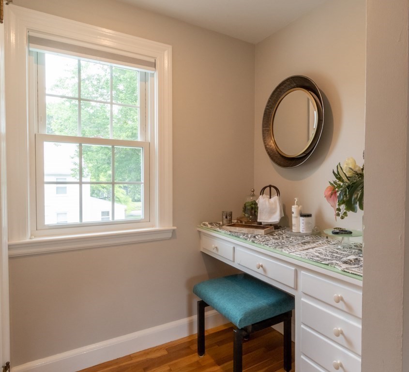 12 Longfellow Road Needham, MA 02494 - Photo 7 of 16 a bathroom with a granite countertop sink a mirror and a window