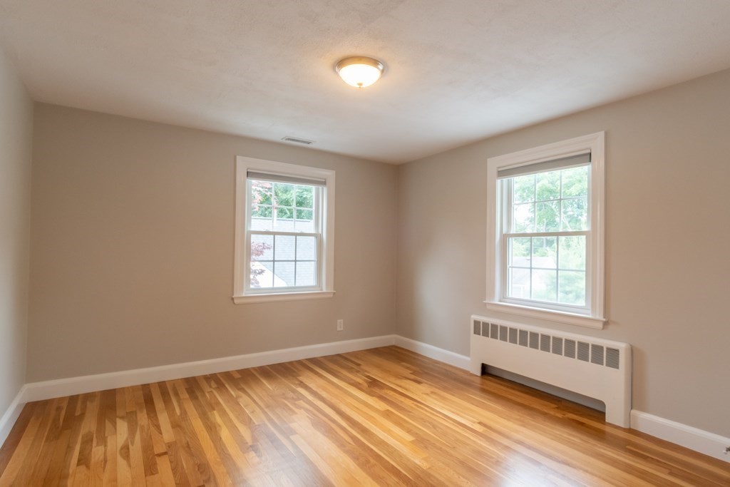 12 Longfellow Road Needham, MA 02494 - Photo 8 of 16 a view of an empty room with wooden floor and a window