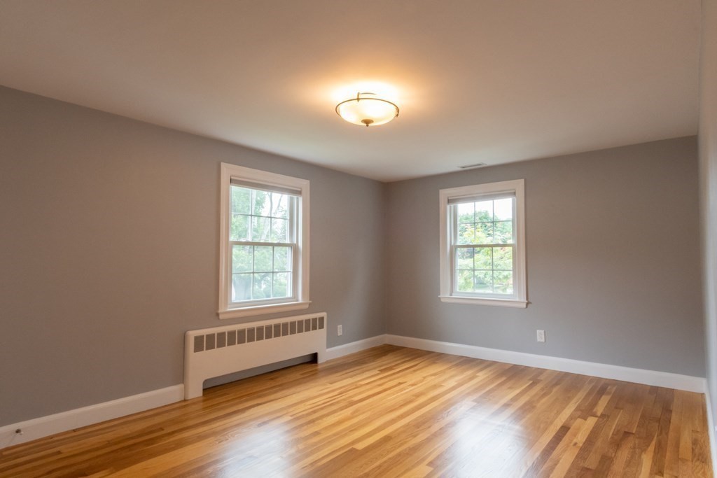 12 Longfellow Road Needham, MA 02494 - Photo 9 of 16 a view of an empty room with wooden floor and a window