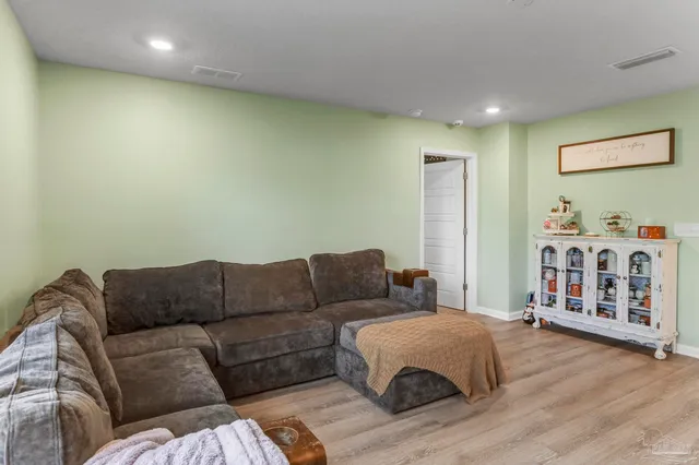 a living room with furniture ceiling fan and a couch