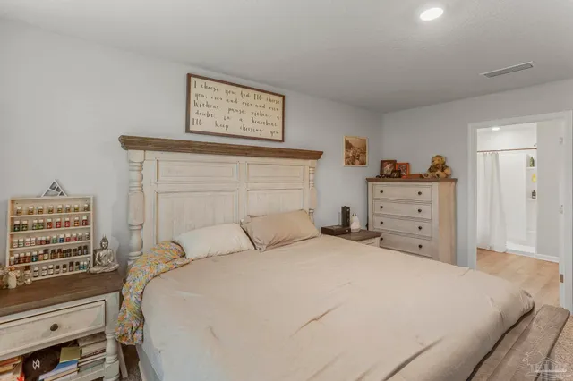 a bedroom with a bed and a cabinets