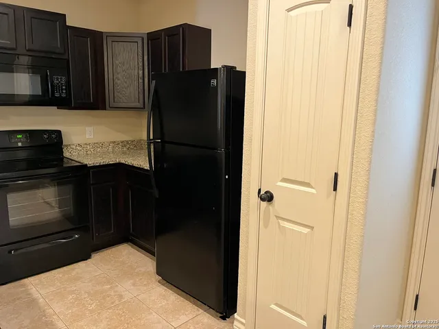 a kitchen with a stove and a cabinets