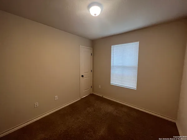 an empty room with closet area