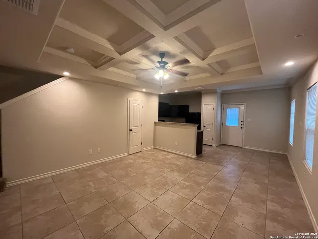 a view of a livingroom with a kitchen and a stove
