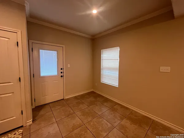 a view of kitchen with refrigerator and cabinets
