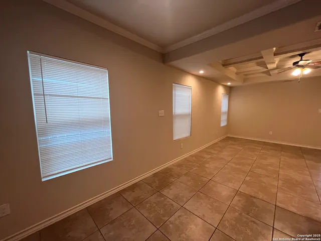 a kitchen with granite countertop a refrigerator and a stove top oven