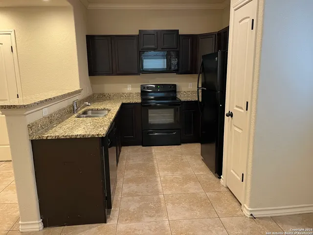 a kitchen with a refrigerator and cabinets