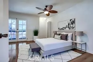 a bedroom with a large bed chandelier and a window