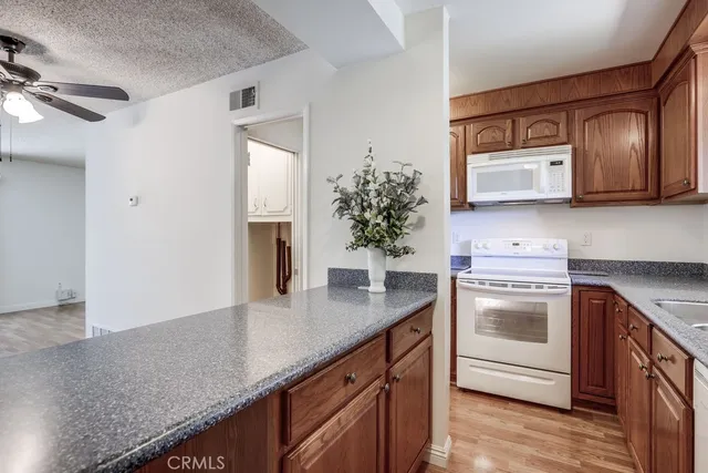 a kitchen with stainless steel appliances granite countertop a sink stove and microwave