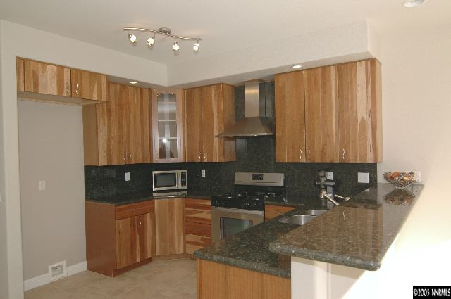 1990 Dickerson Road Reno, NV 89503 - Photo 2 of 9 a kitchen with granite countertop a sink a stove and a refrigerator