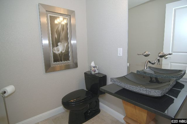 1990 Dickerson Road Reno, NV 89503 - Photo 7 of 9 a bathroom with a granite countertop sink and a mirror