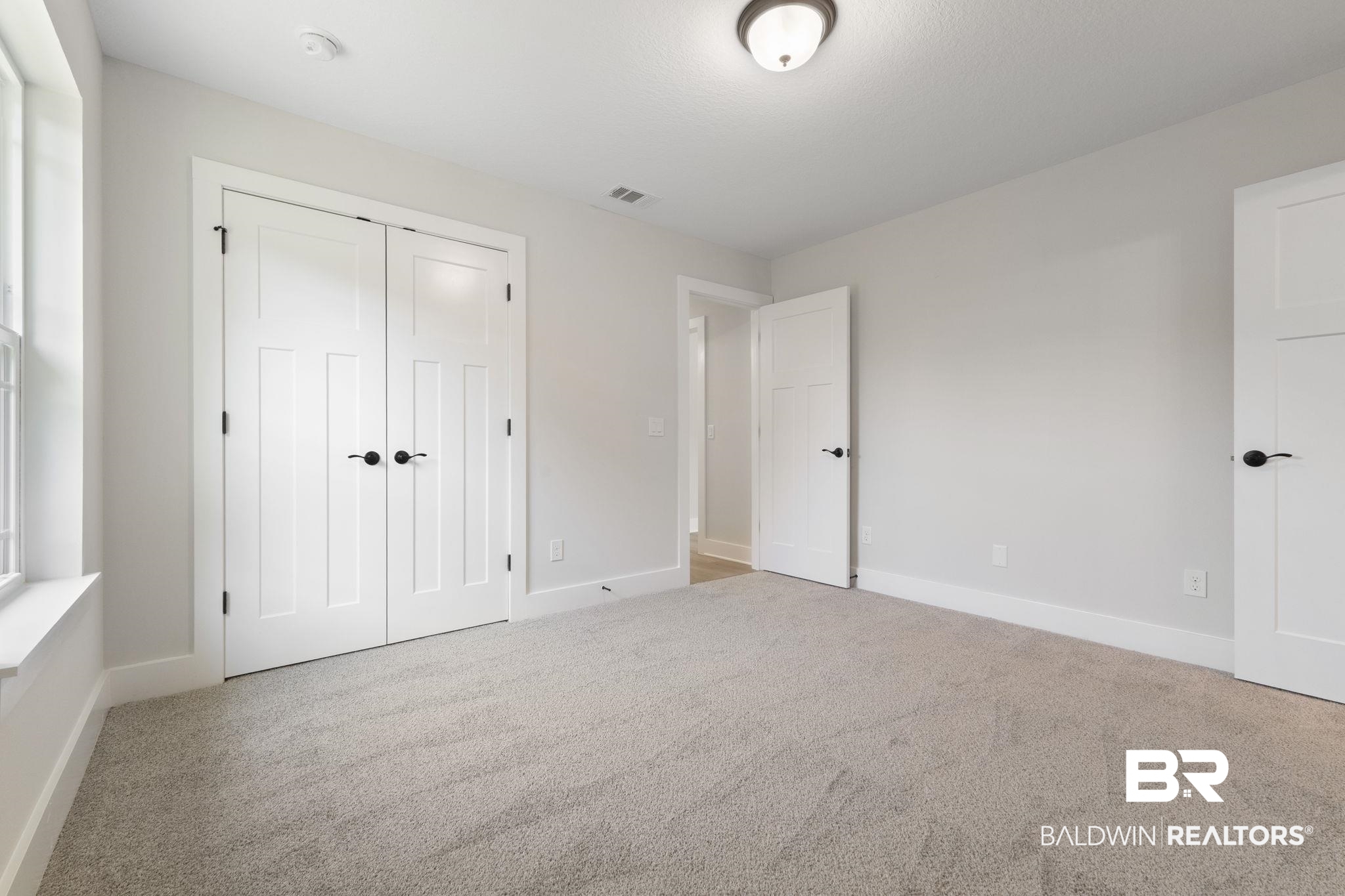 32563 Arbor Ridge Circle Lillian, AL 36549 - Photo 25 of 53 Unfurnished bedroom with light carpet and a closet