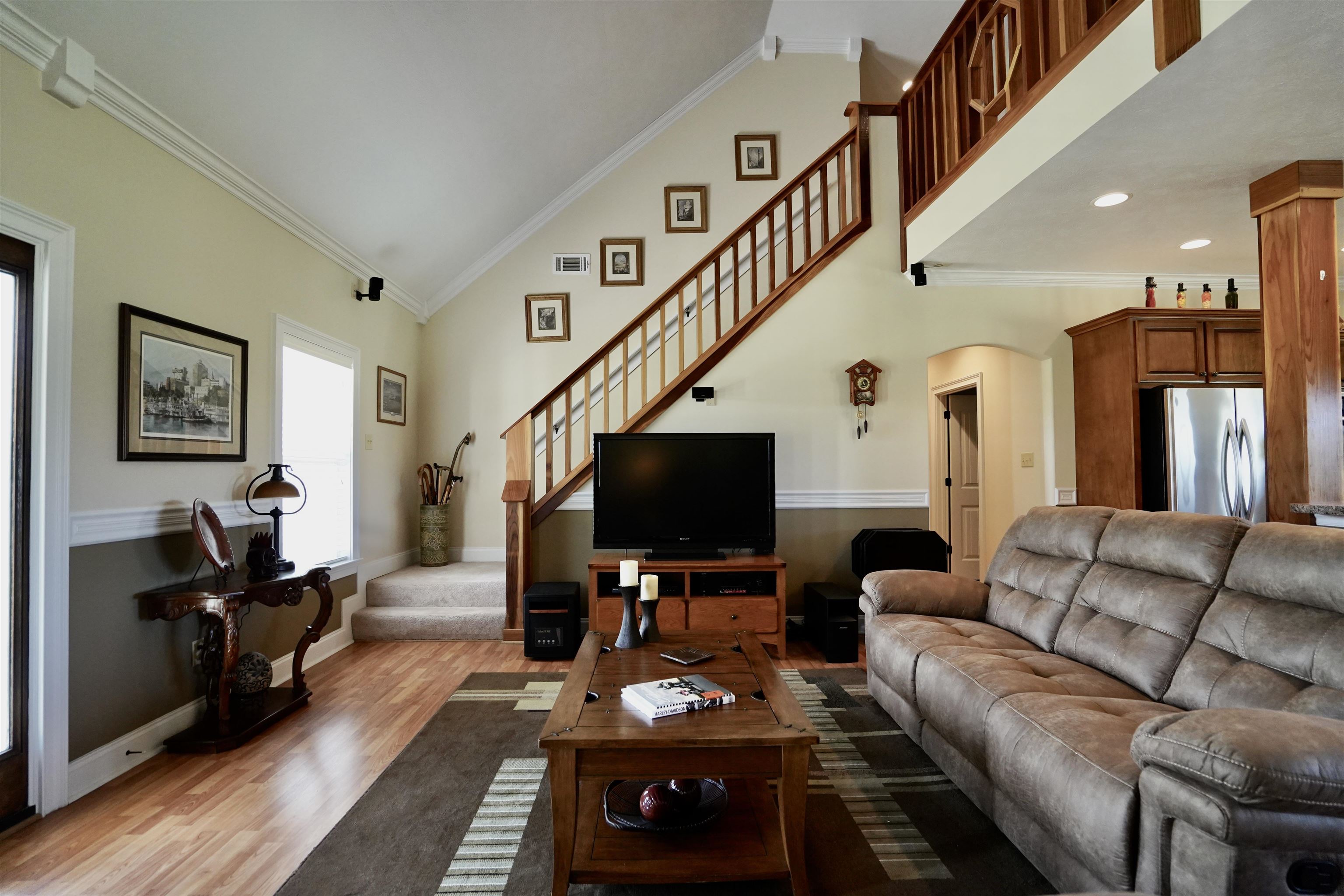 4556 Gainsville Road Mason, TN 38049 - Photo 17 of 33 Living room with high vaulted ceiling, light hardwood / wood-style floors, and crown molding