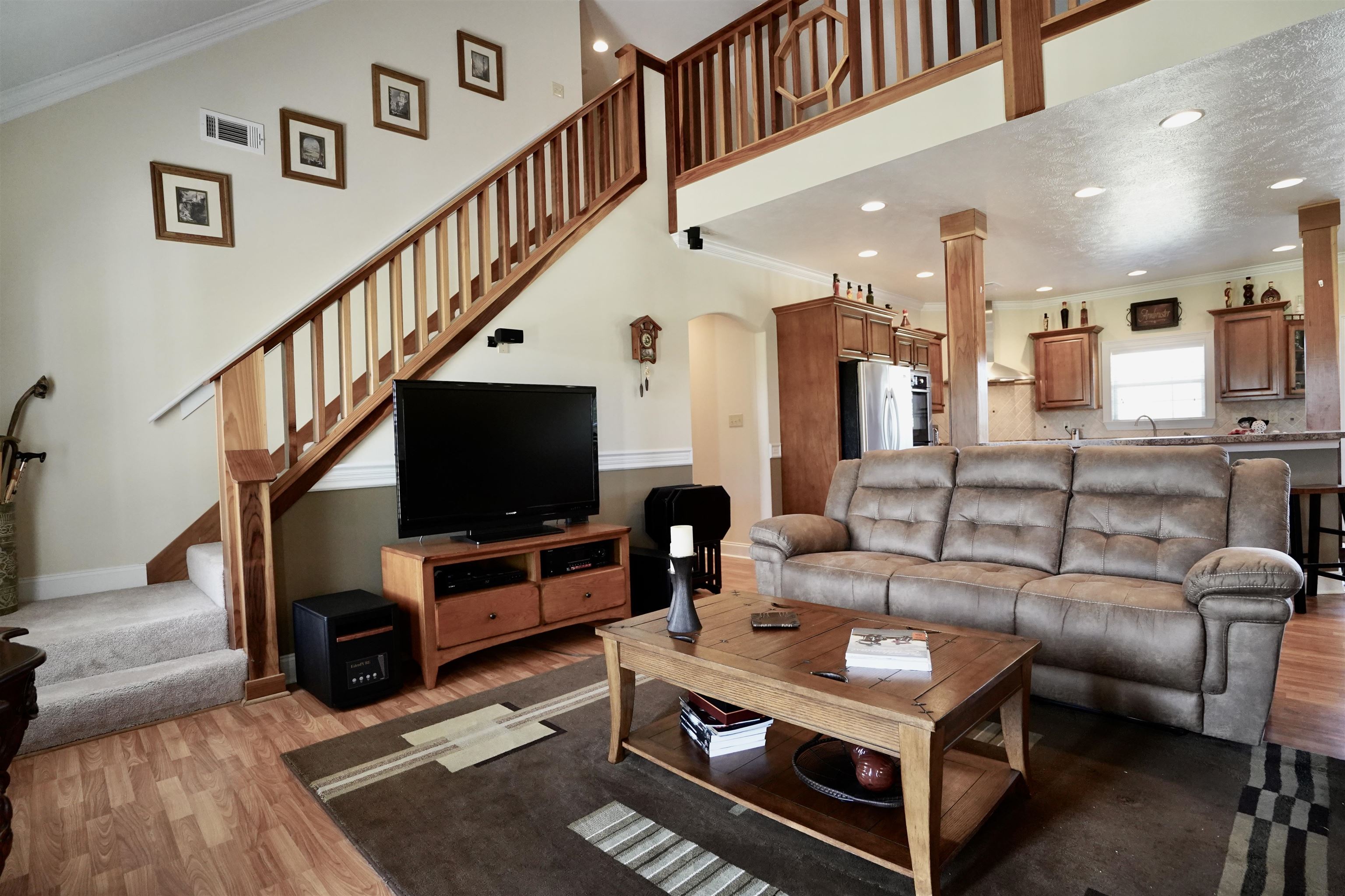 4556 Gainsville Road Mason, TN 38049 - Photo 20 of 33 Living room with a towering ceiling, dark hardwood / wood-style flooring, and ornamental molding