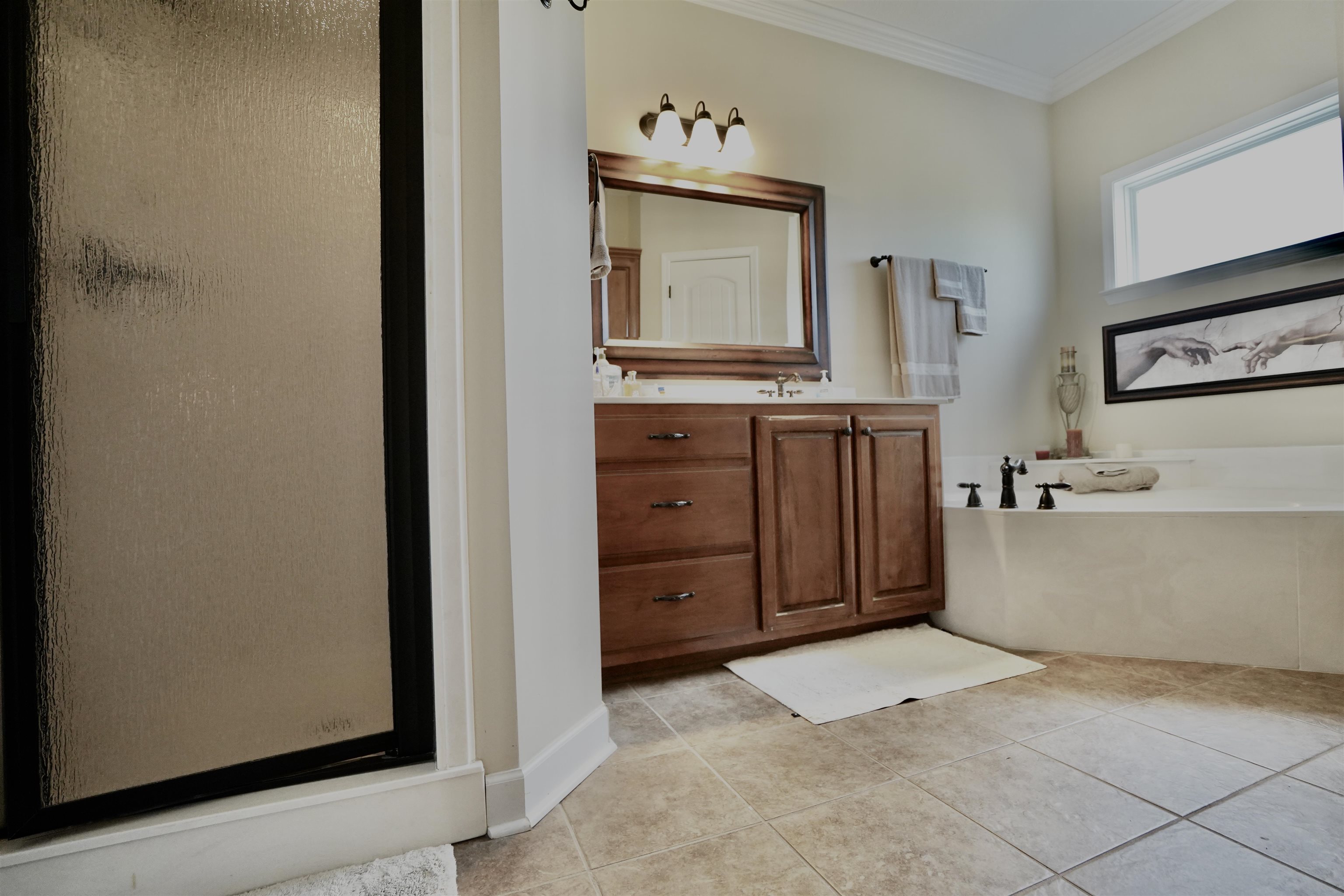 4556 Gainsville Road Mason, TN 38049 - Photo 30 of 33 Bathroom featuring crown molding, vanity, separate shower and tub, and tile patterned floors