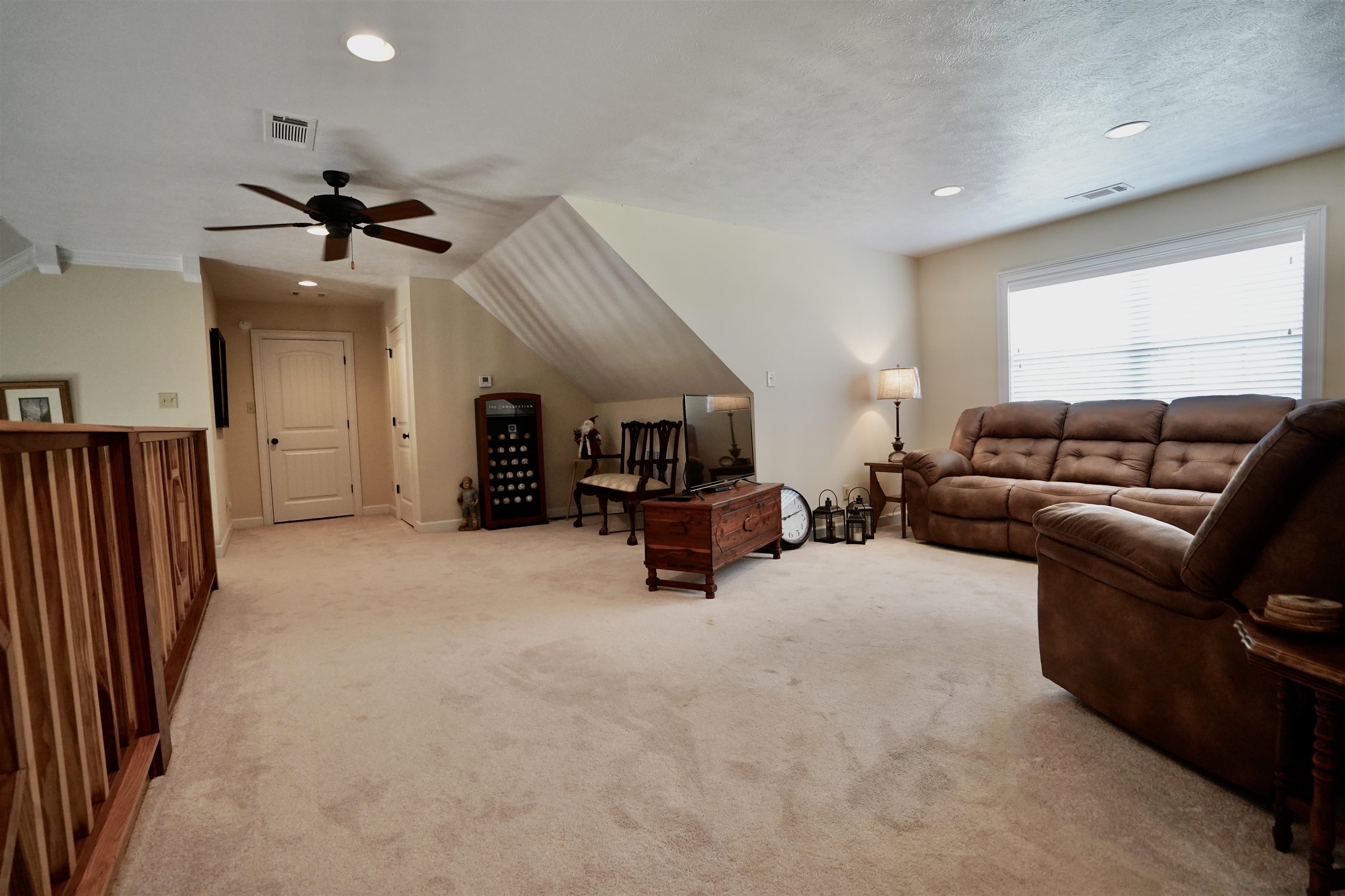 4556 Gainsville Road Mason, TN 38049 - Photo 31 of 33 Living room with lofted ceiling, ceiling fan, light carpet, and a textured ceiling