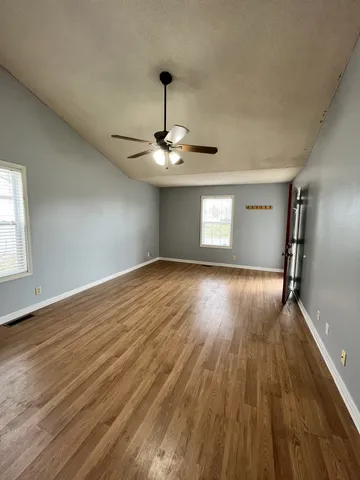 a view of wooden floor and windows in a room