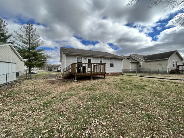 a front view of a house with a garden and trees