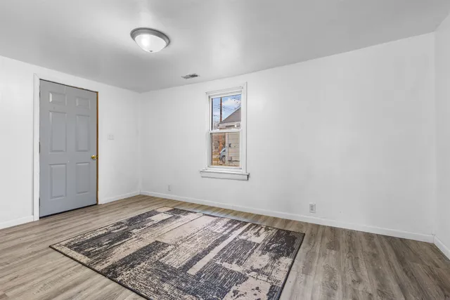 a view of a room with wooden floor and closet