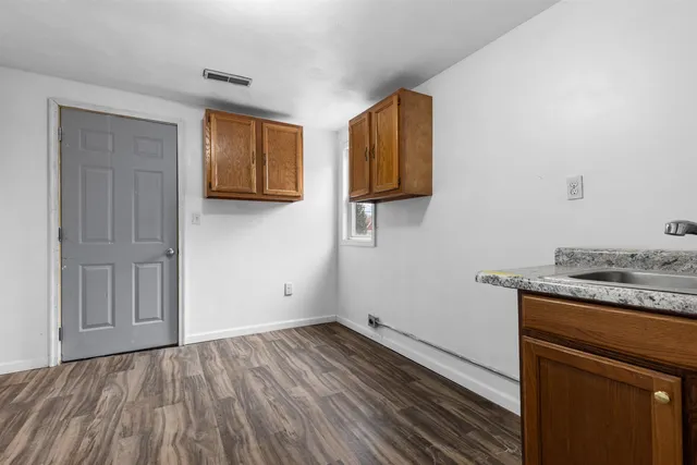 a view of kitchen with sink and wooden floor