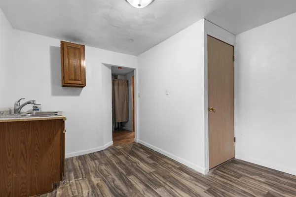 a view of a hallway with wooden floor and closet