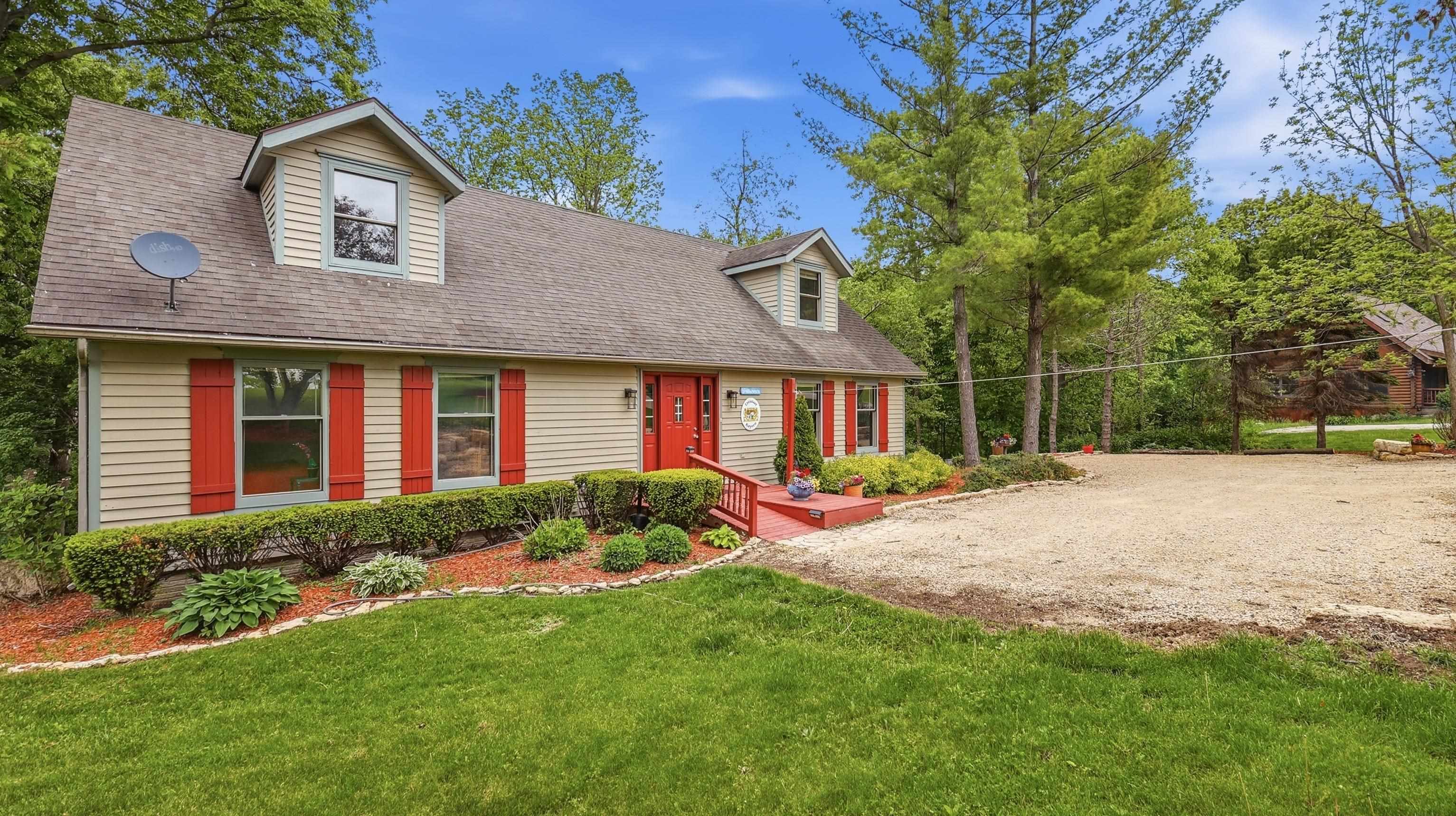 13 Signal Point Lane Galena, IL 61036 - Photo 2 of 47 a front view of a house with a yard and porch