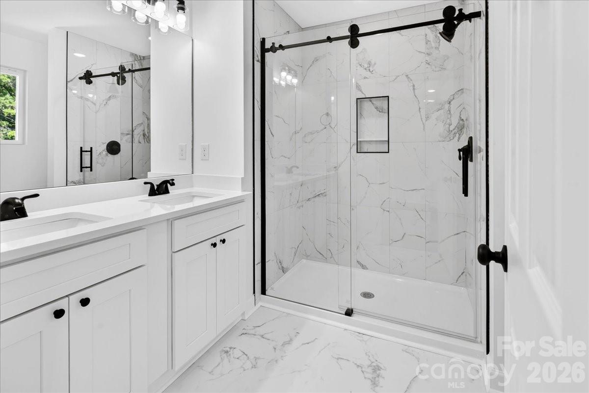 2108 Moose Road Kannapolis, NC 28081 - Photo 15 of 22 a bathroom with a shower sink and mirror