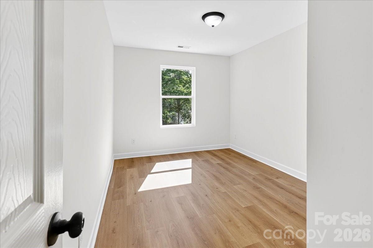 2108 Moose Road Kannapolis, NC 28081 - Photo 16 of 22 an empty room with wooden floor and windows