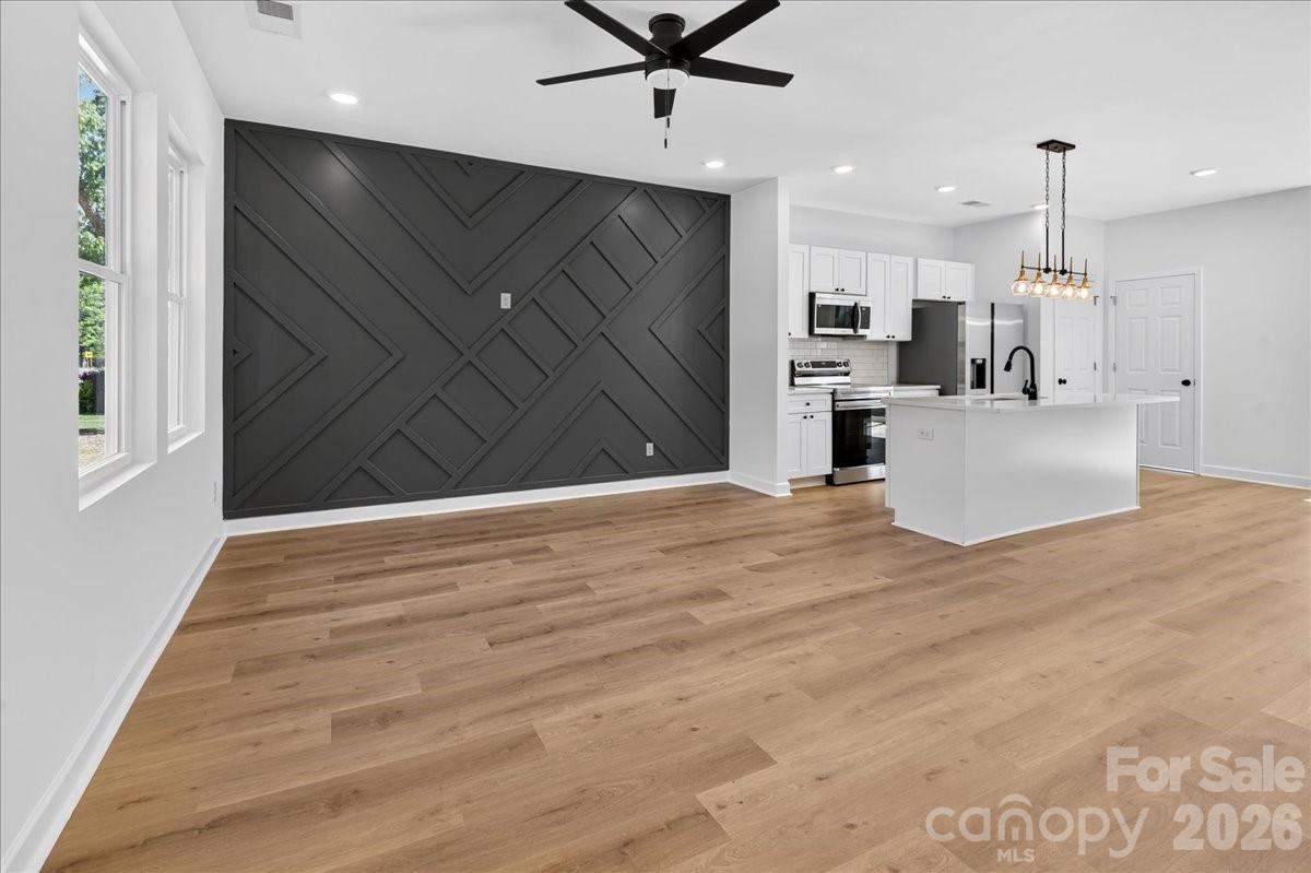 2108 Moose Road Kannapolis, NC 28081 - Photo 5 of 22 a view of a workspace with wooden floor and kitchen space